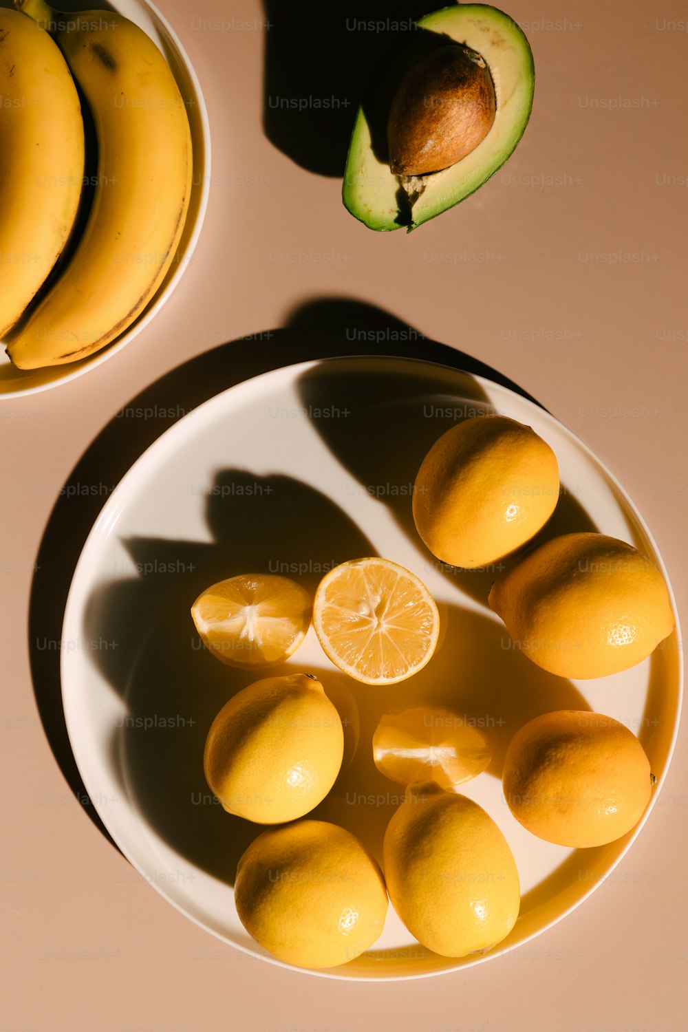 a white plate topped with lemons and bananas
