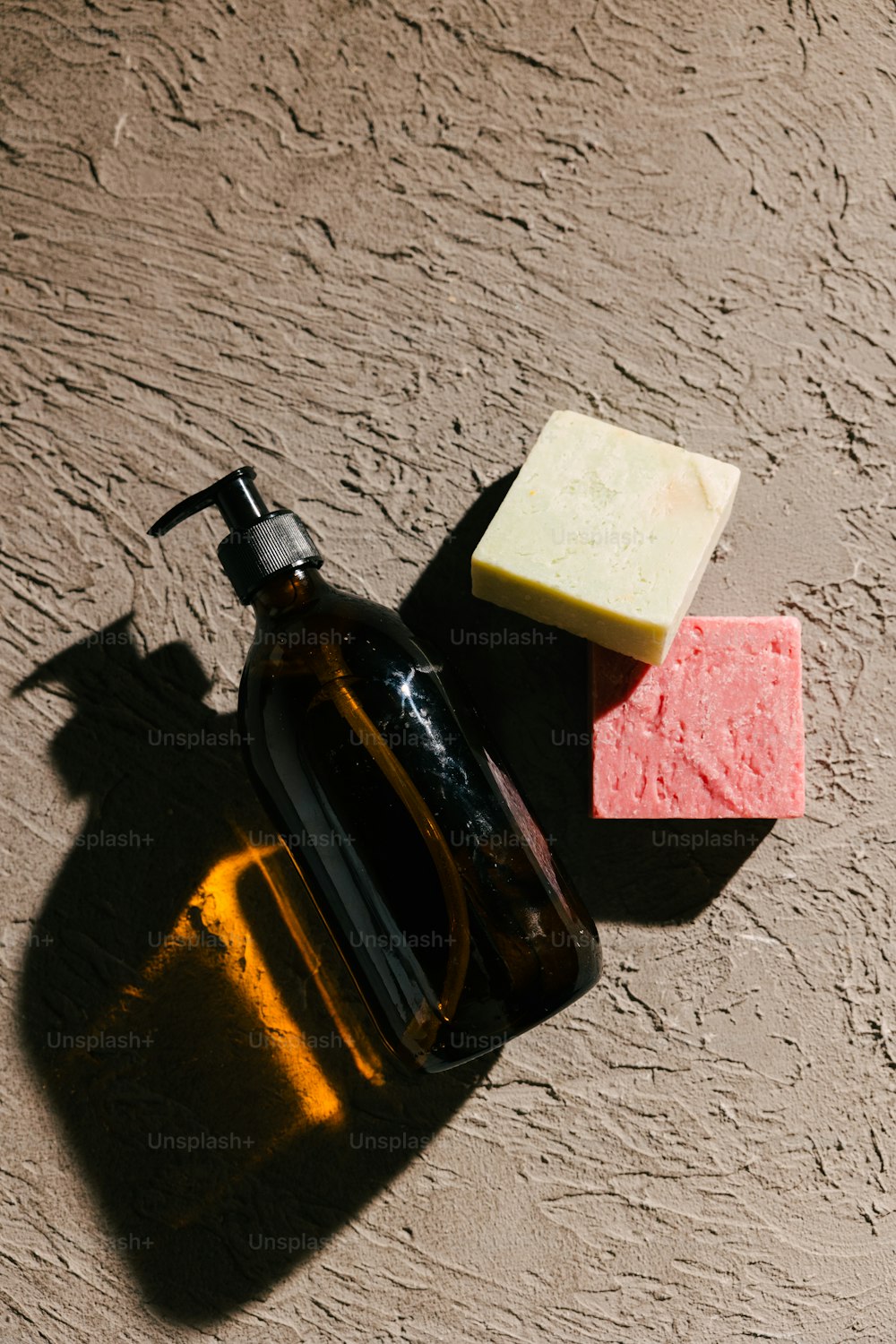 a bottle of soap next to a soap bar