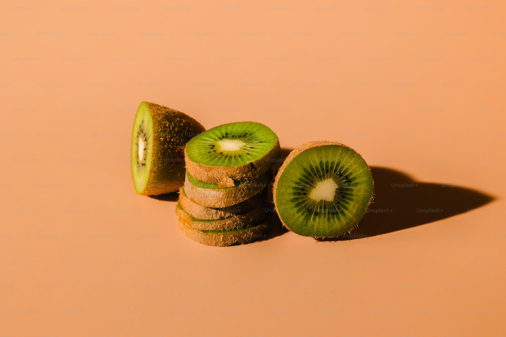 a kiwi cut in half sitting on top of a table