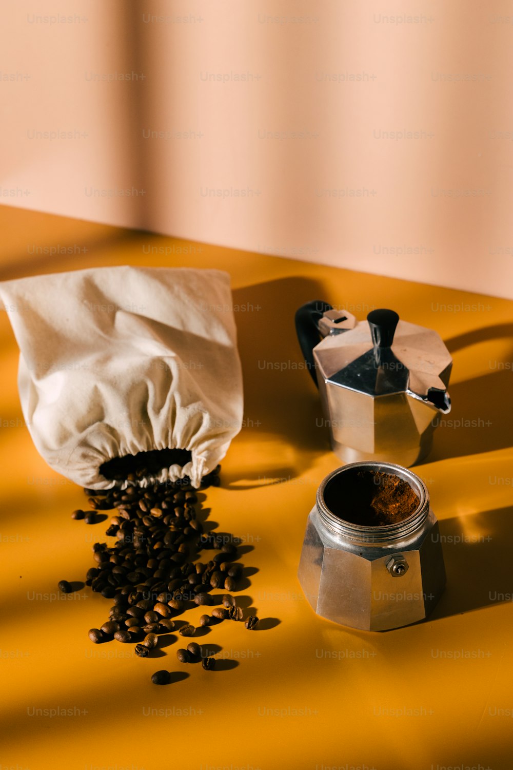 a can of coffee next to a container of coffee beans