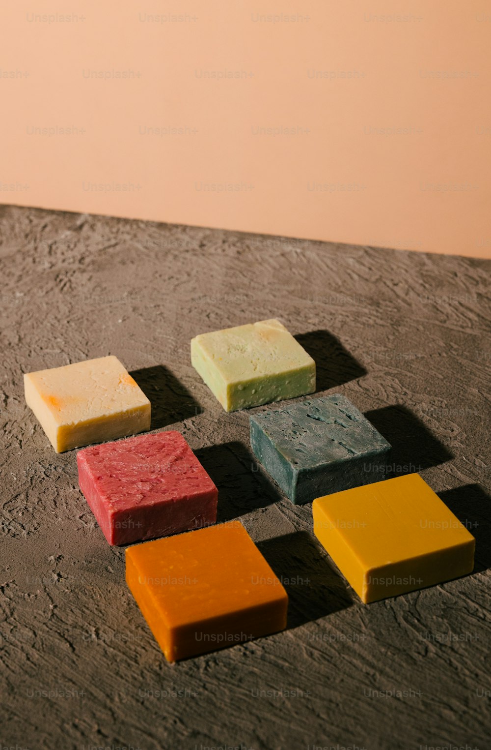 a group of different colored blocks of soap