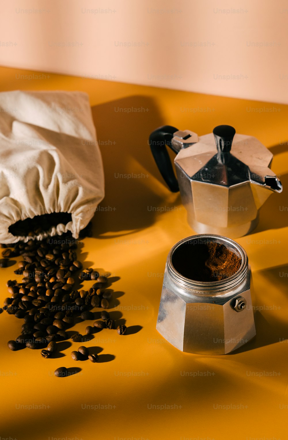 a coffee pot and grinder sitting on a table