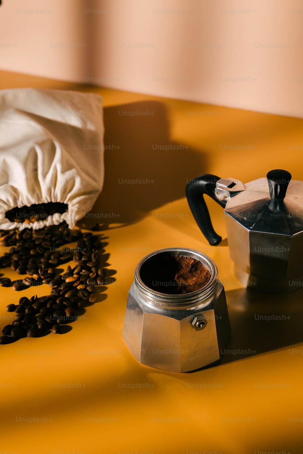 a coffee pot and a grinder on a table