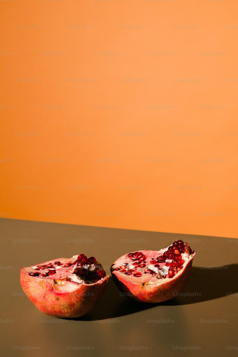 two halves of a pomegranate sitting on a table