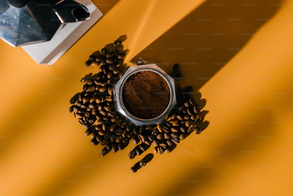 a cup of coffee next to a pile of coffee beans