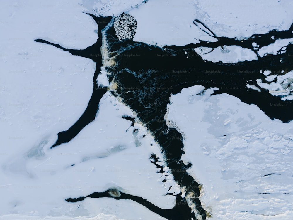 a snowboarder riding down a snow covered slope