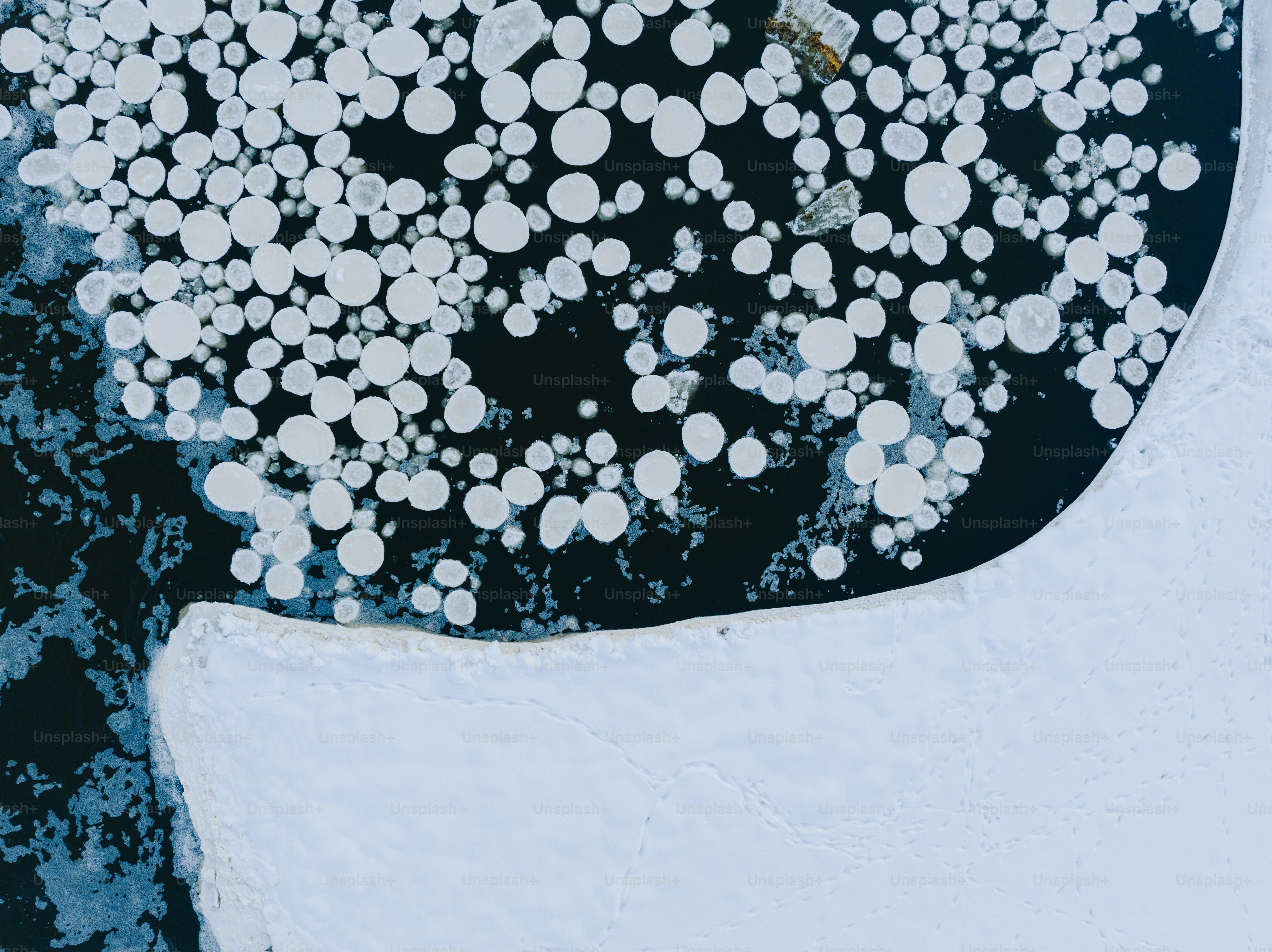 a large amount of ice floating on top of a body of water