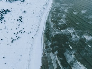 an aerial view of a beach covered in snow