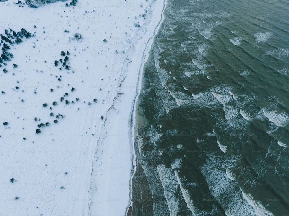 an aerial view of a beach covered in snow