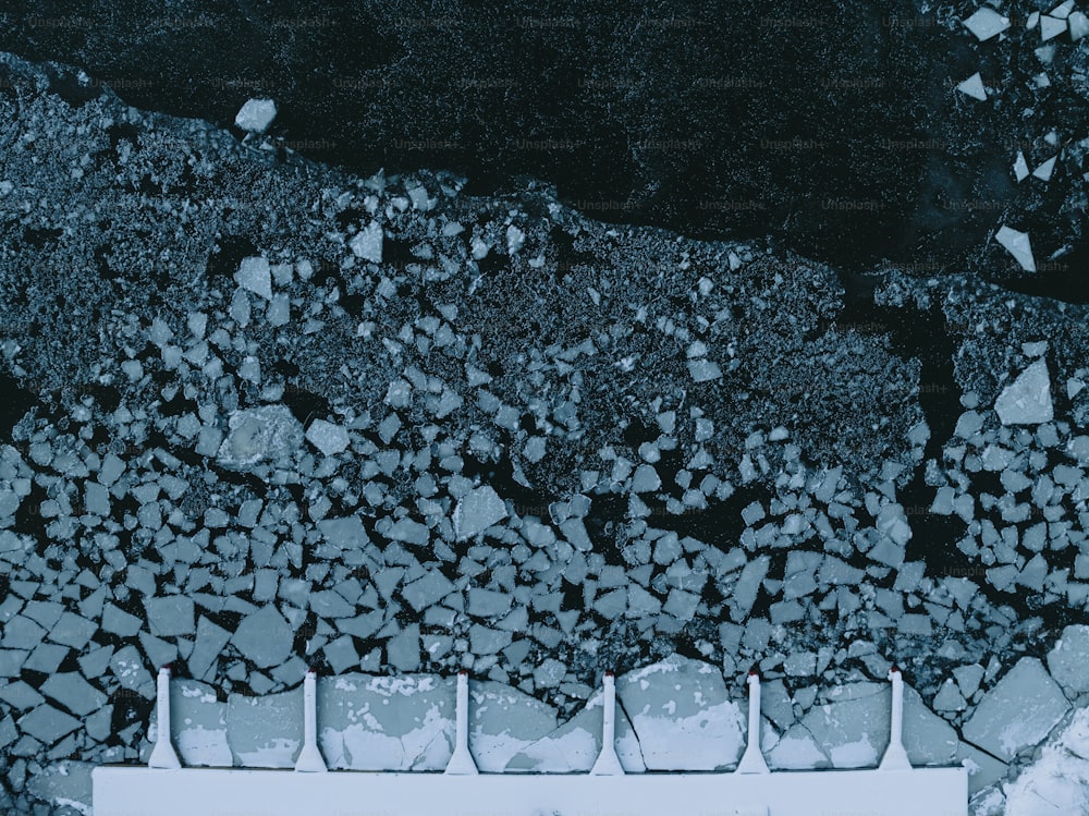 a white bench sitting on top of a pile of rocks