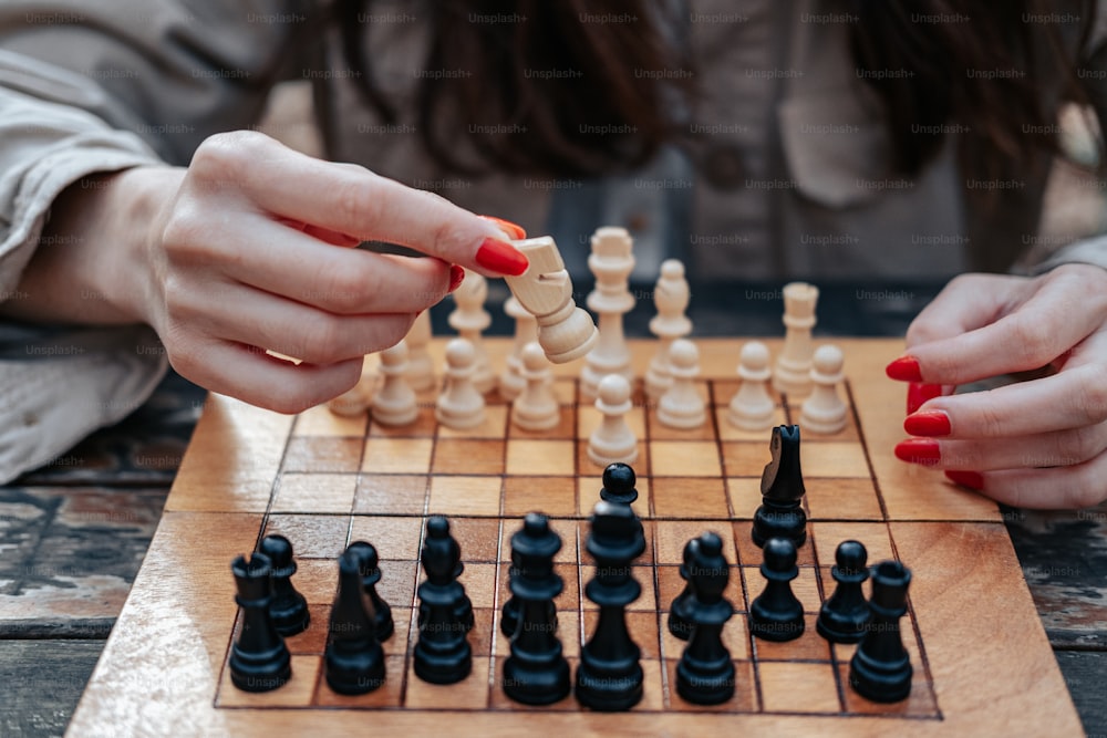 a woman is playing a game of chess