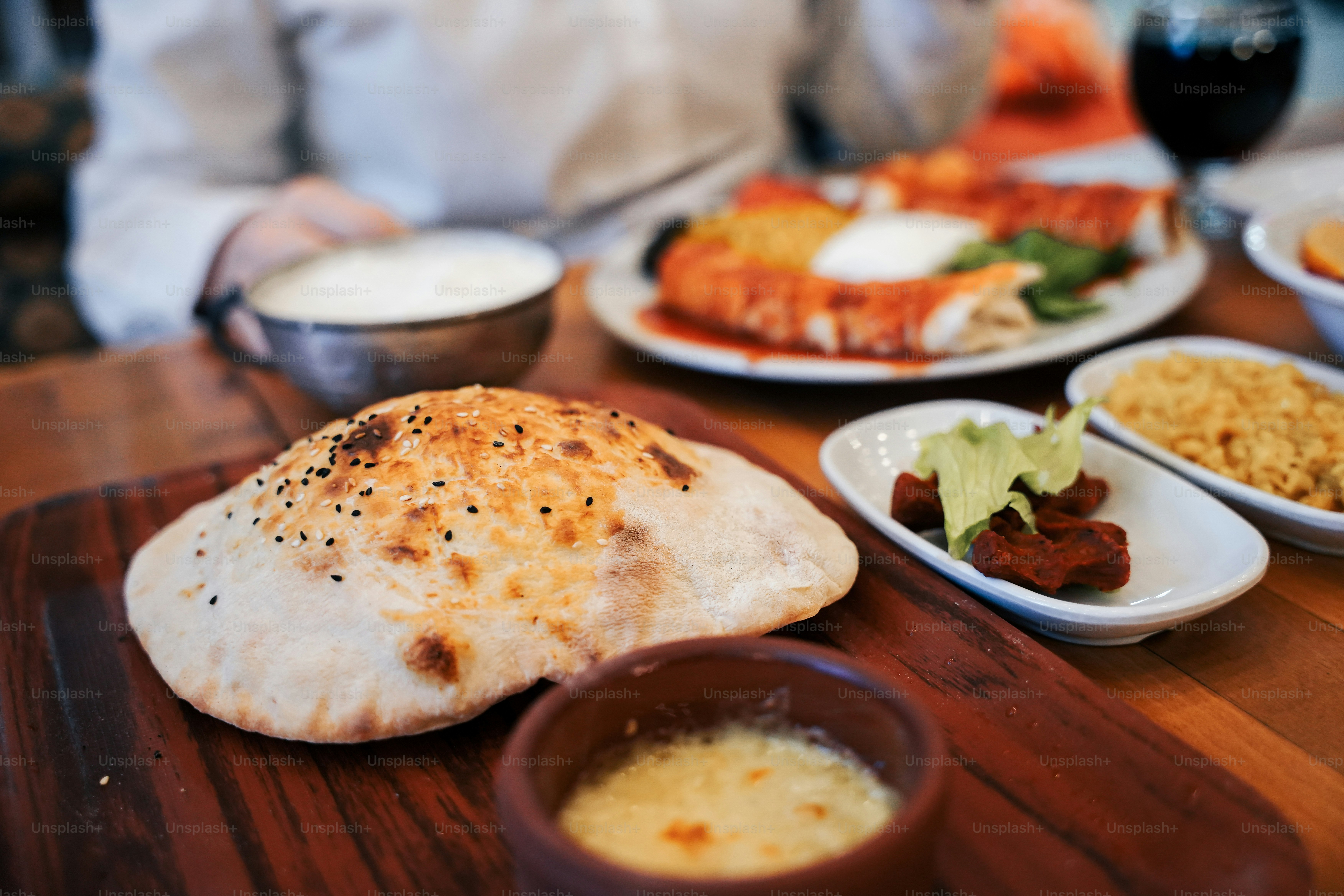 a wooden table topped with plates of food