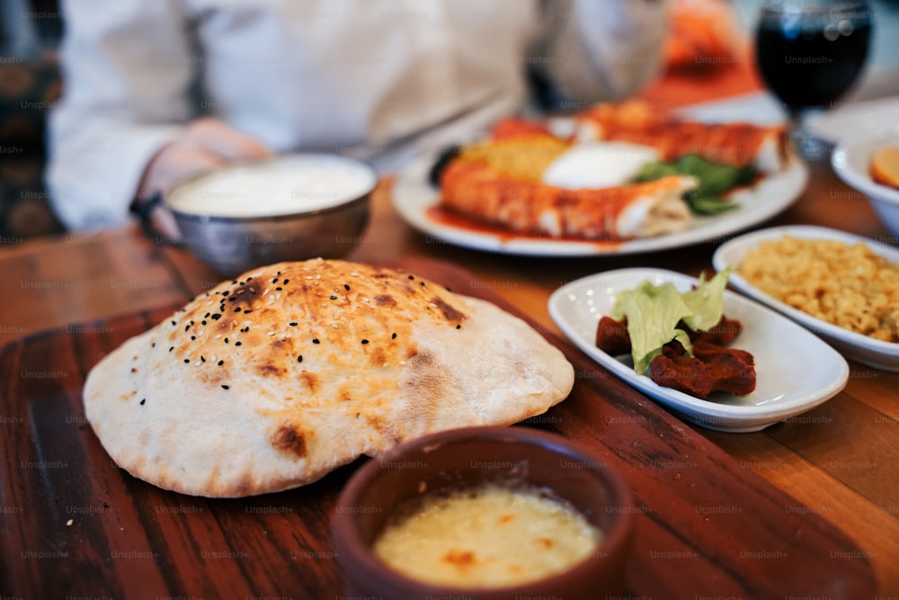 a wooden table topped with plates of food