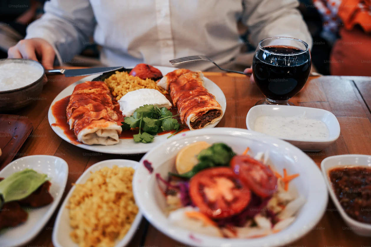 Diner seated at a table with a plated meal, reinforcing the article's focus on Rio's night dining and restaurant experience.
