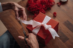 a person cutting a piece of paper with scissors