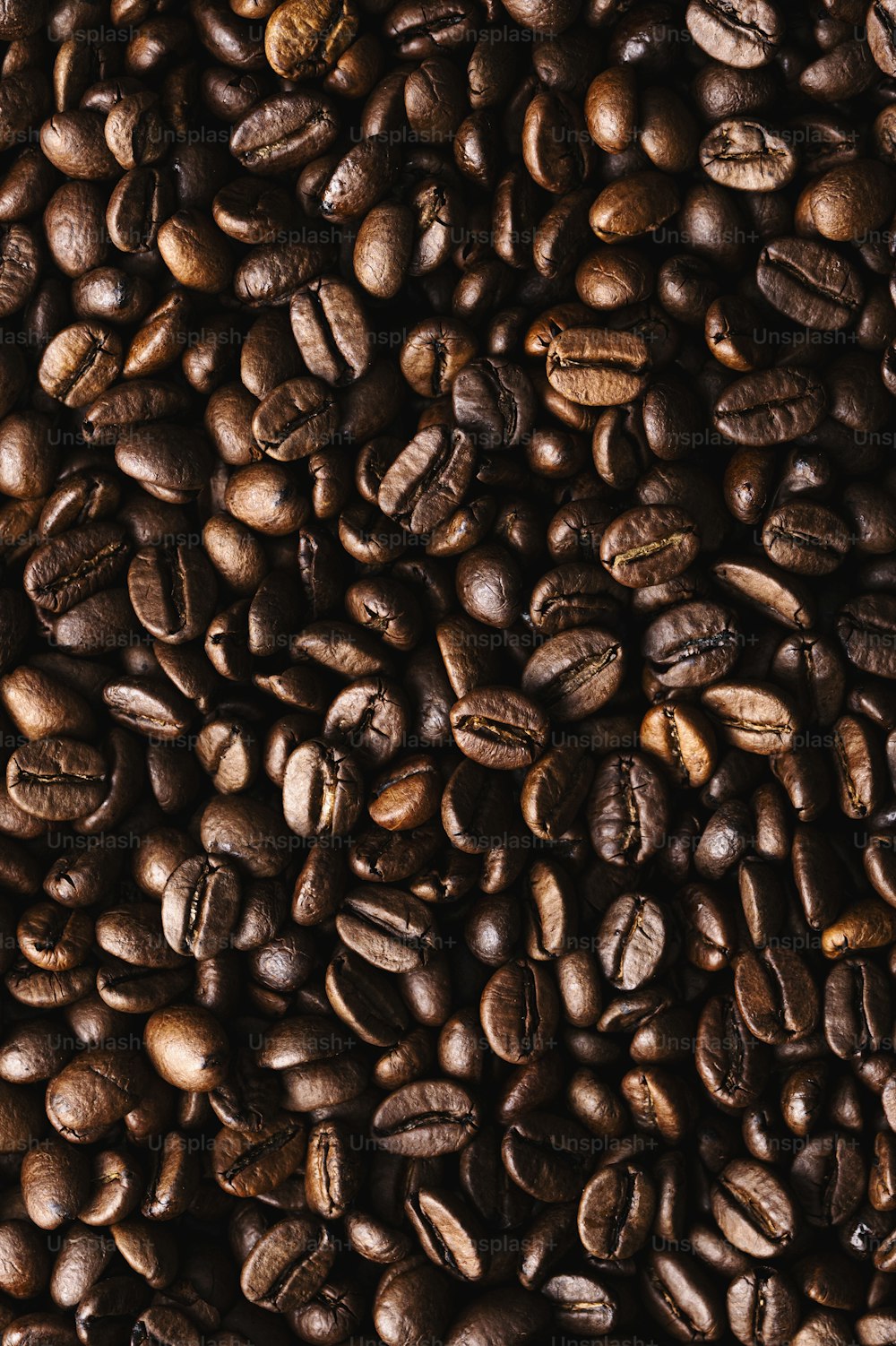 a pile of coffee beans is shown in this image