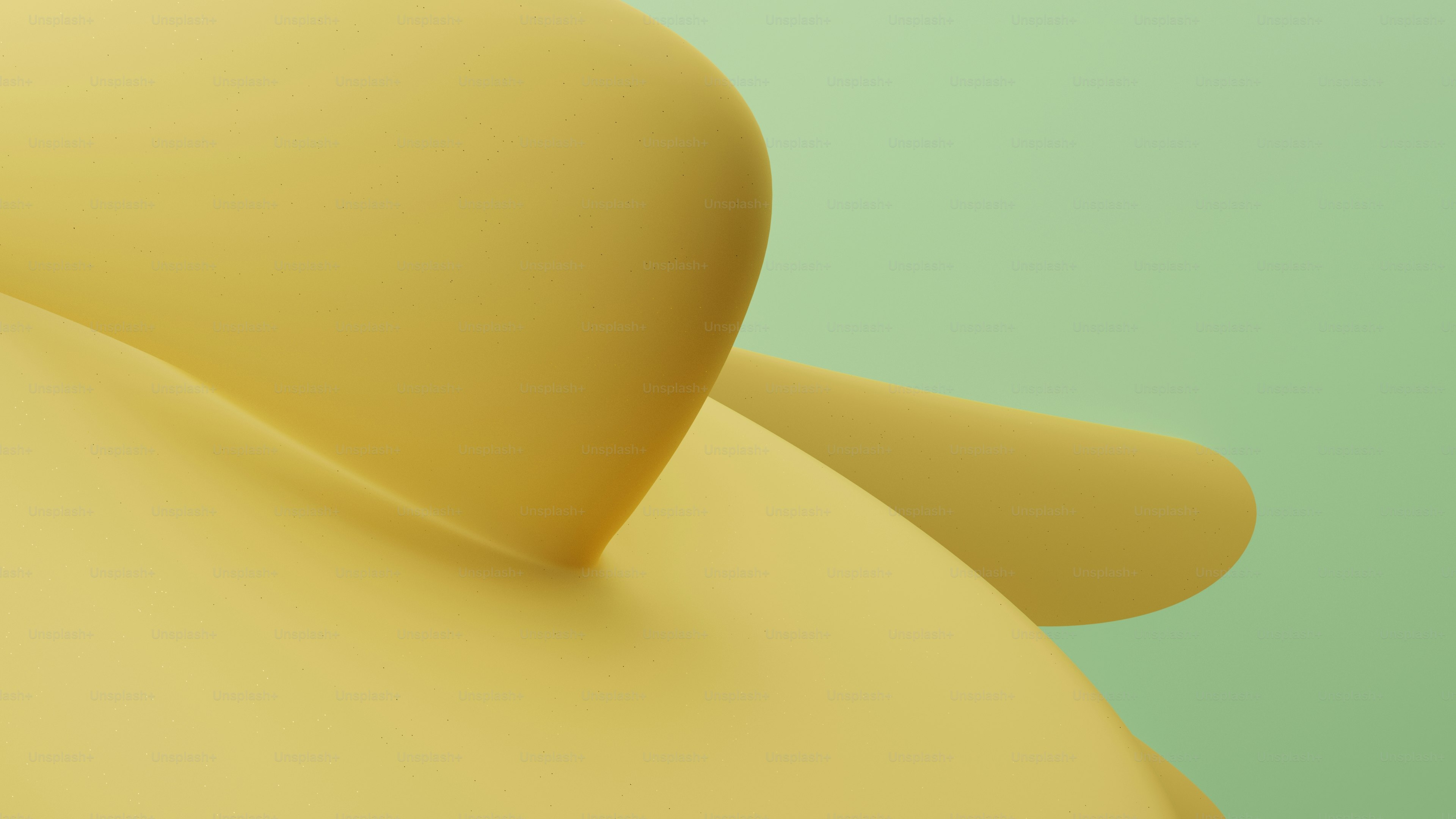 a close up of a yellow object on a green background