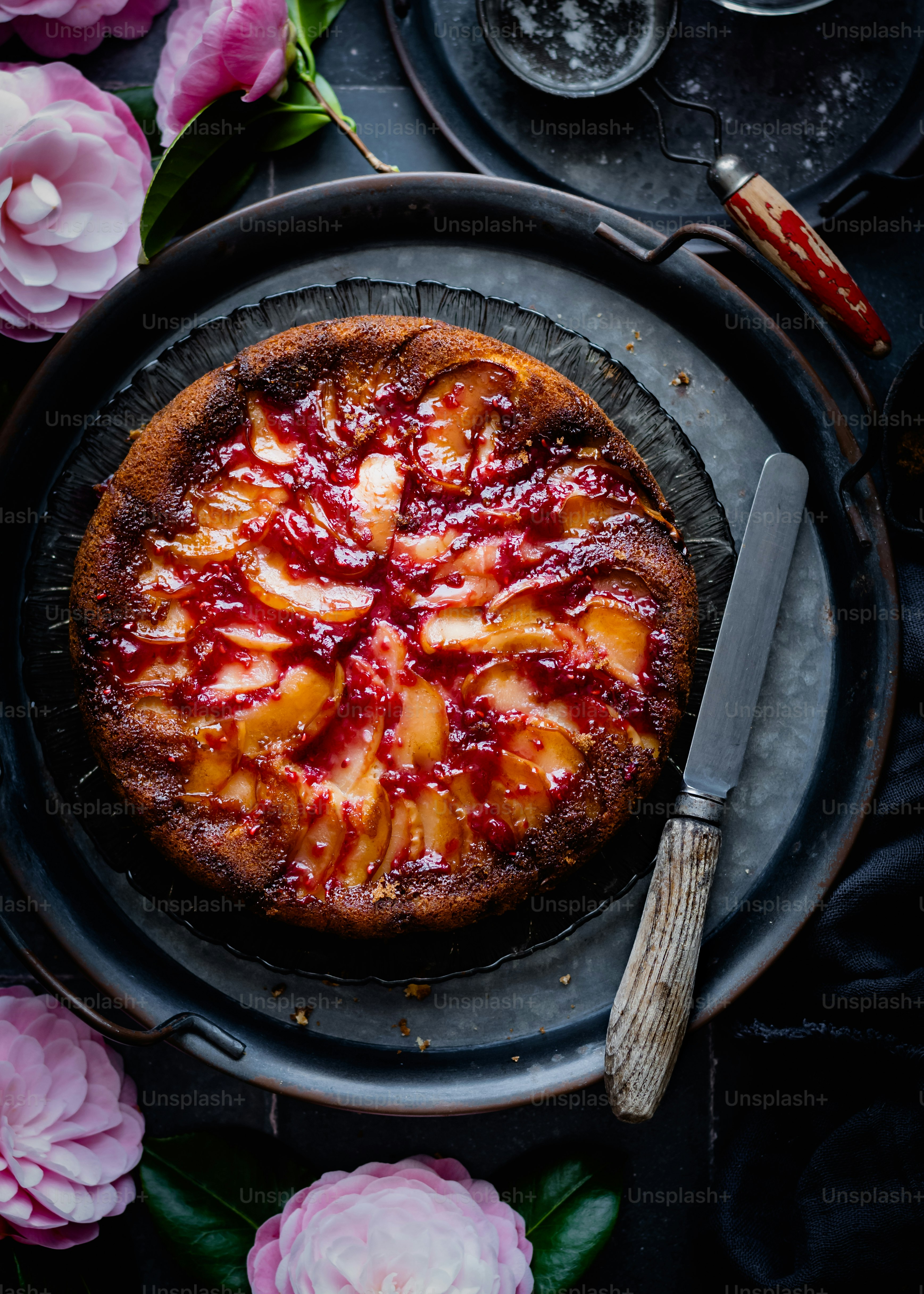 a cake on a plate with flowers around it