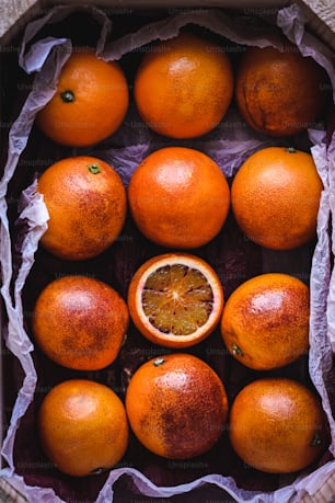 a bunch of oranges that are in a box