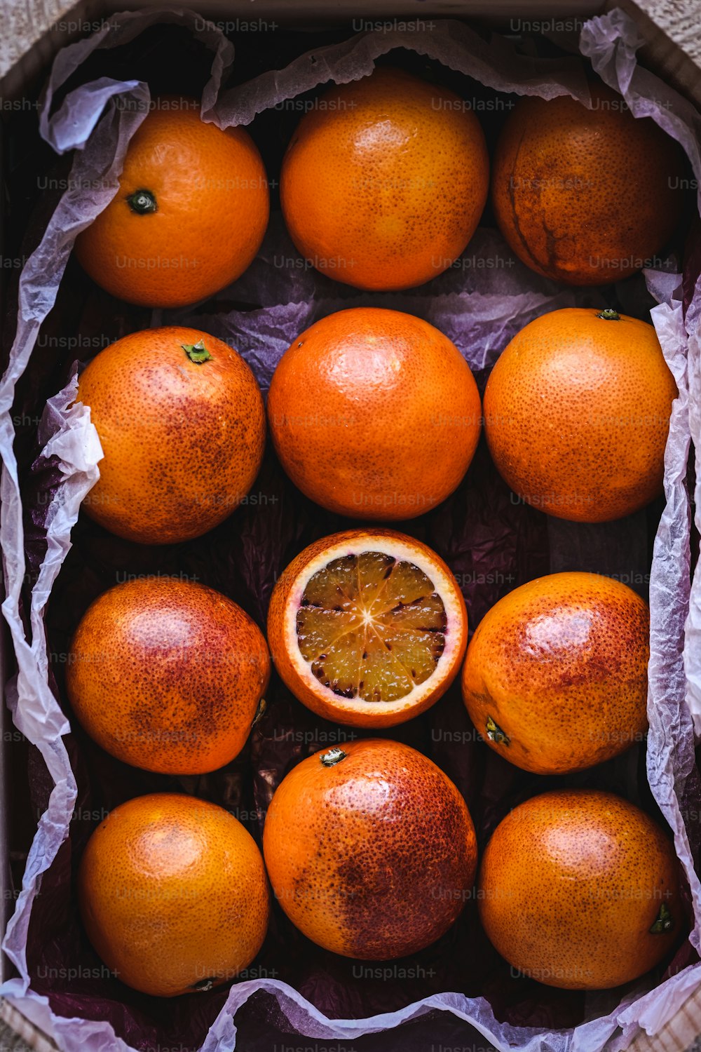 a bunch of oranges that are in a box