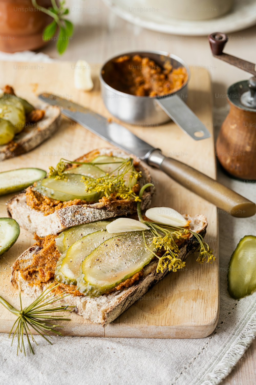 a wooden cutting board topped with sliced cucumbers