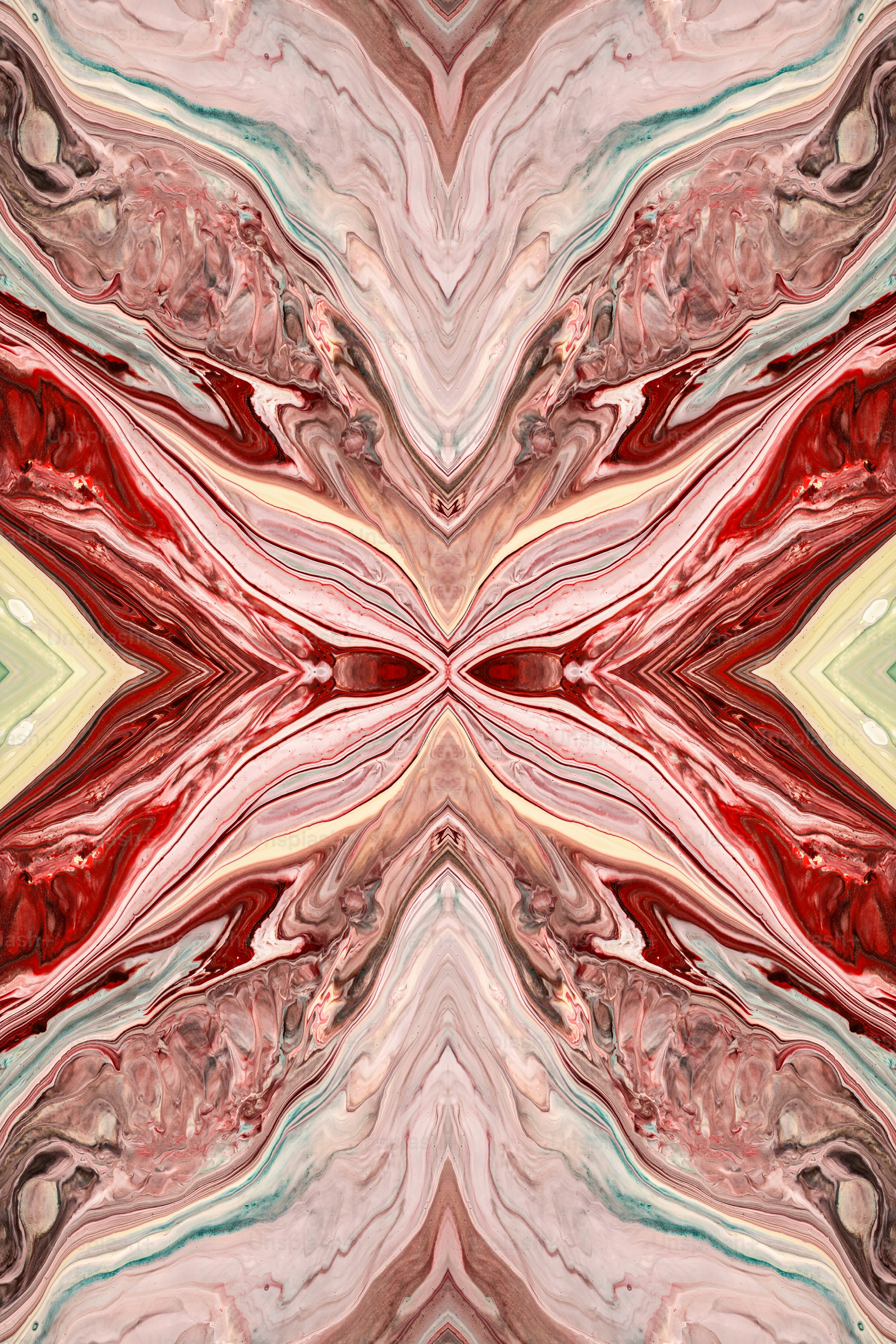 Una imagen abstracta de formas rojas, rosas y verdes