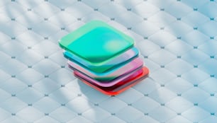 a stack of colorful plastic plates sitting on top of a white surface