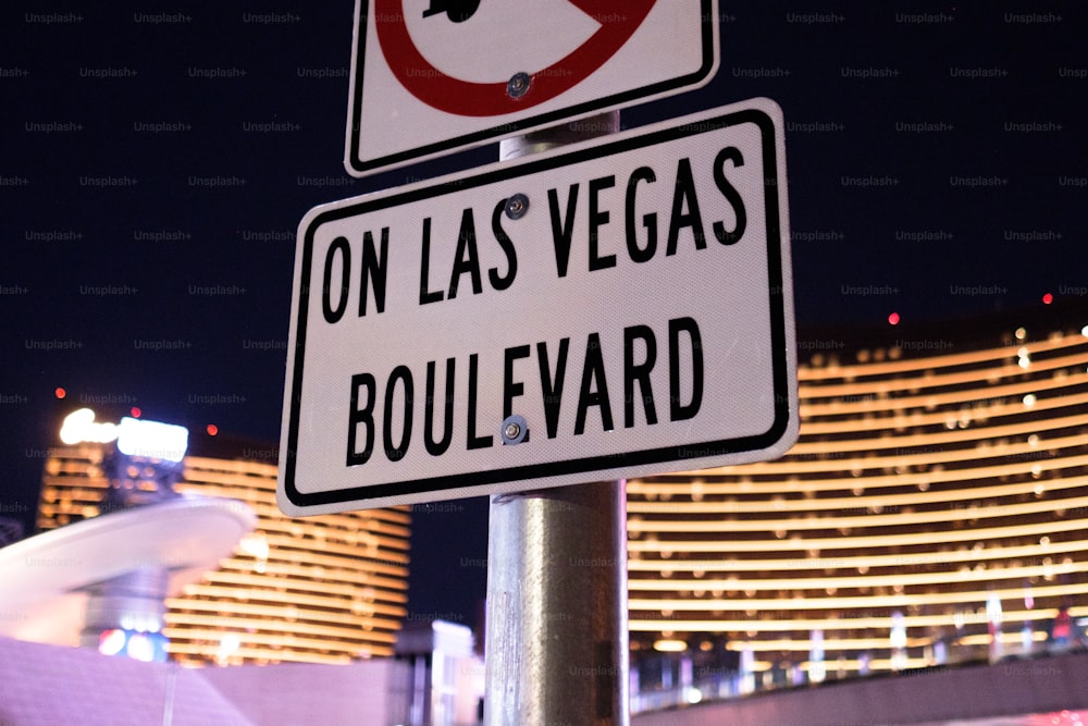 a street sign with a hotel in the background