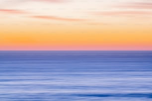 a blurry photo of the ocean at sunset