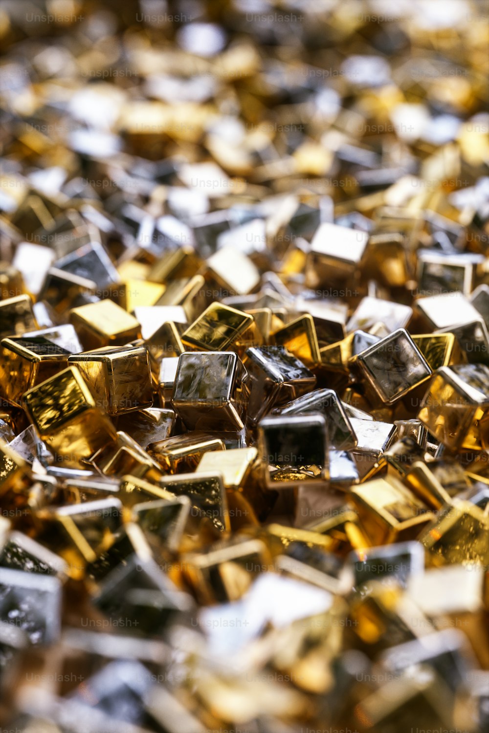 a pile of gold and silver cubes sitting on top of each other