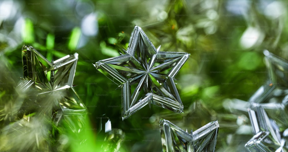 a group of glass stars sitting on top of a lush green field