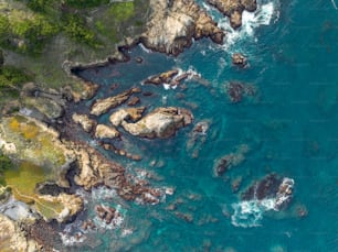 a bird's eye view of the ocean and rocks