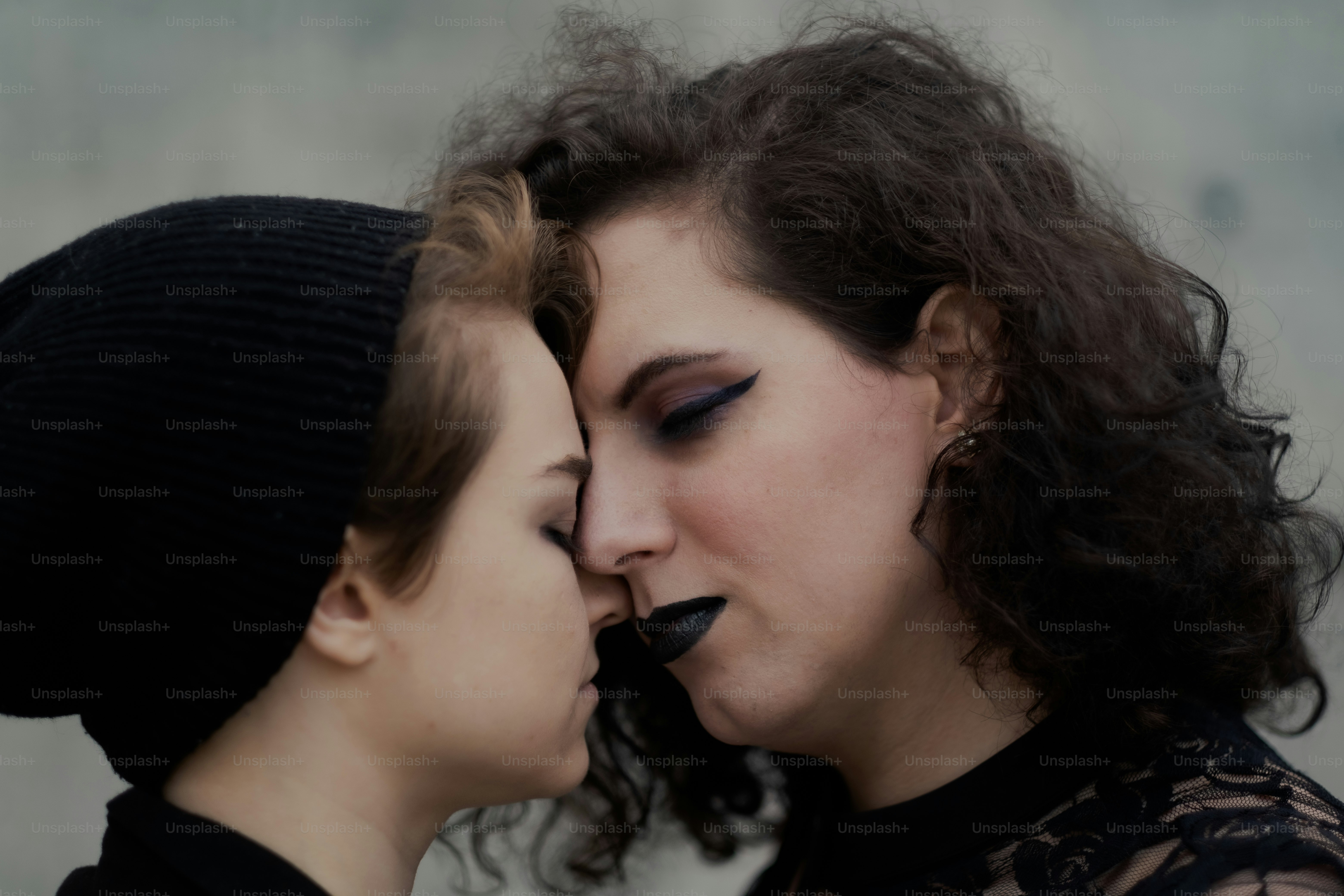 Socks (agender, they/them; on left) and Crystal (woman of trans experience, she/her; on right) sharing a romantic moment.