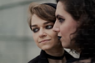 a close up of two women with black makeup