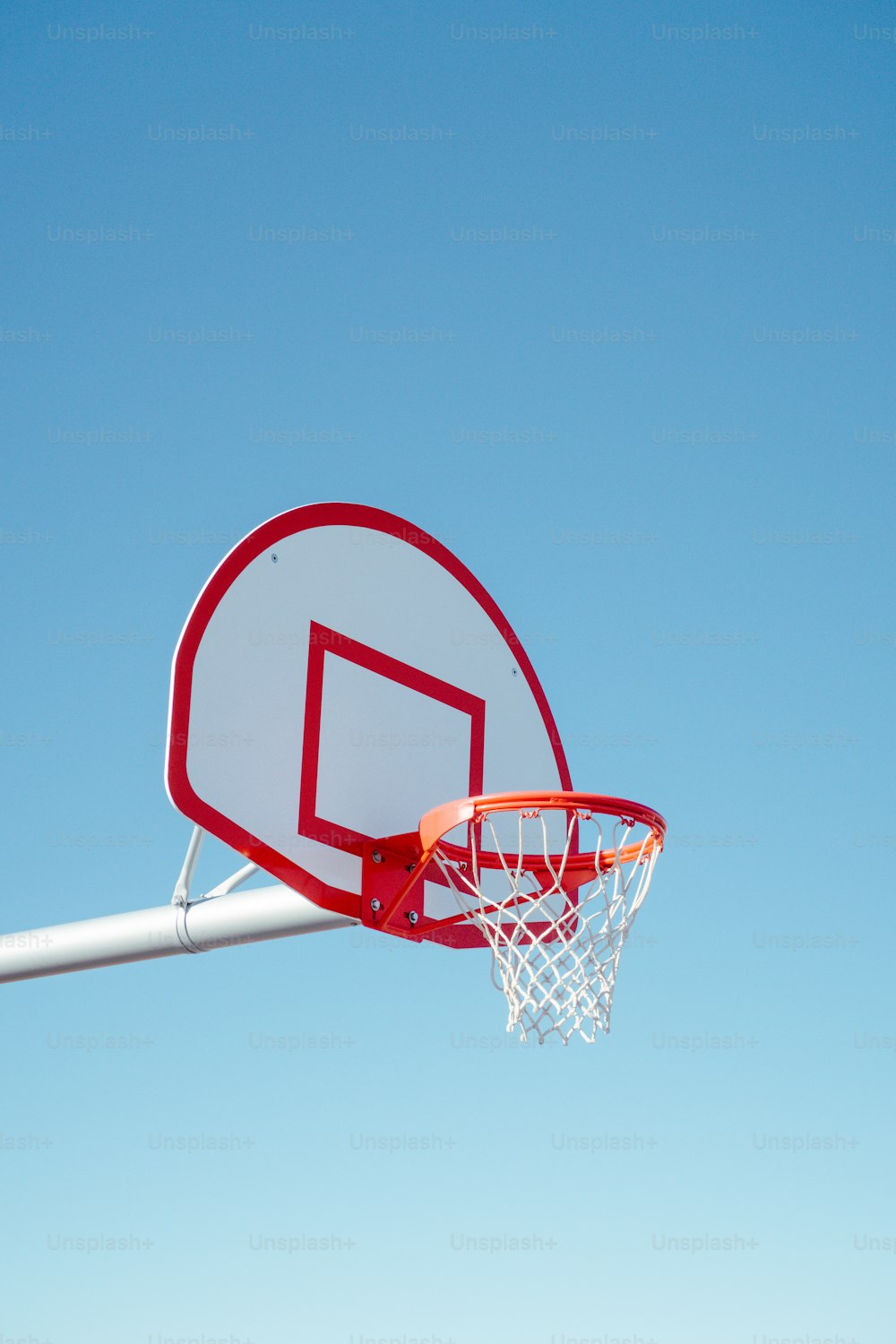 a basketball hoop with a clear blue sky in the background