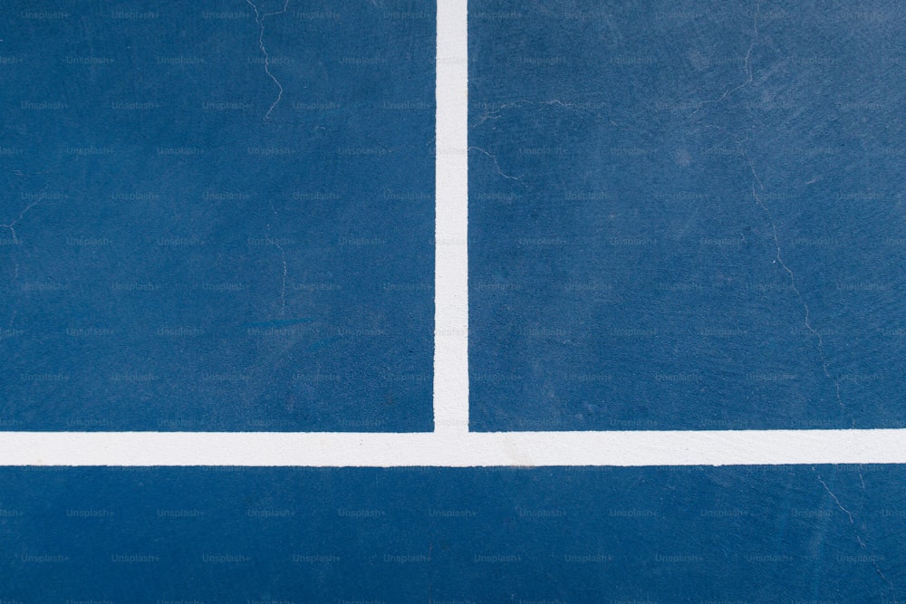 a blue tennis court with white lines on it