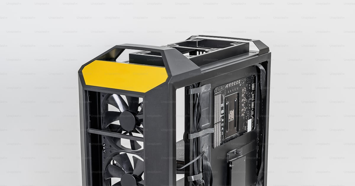 A black and yellow computer case on a white background photo ...