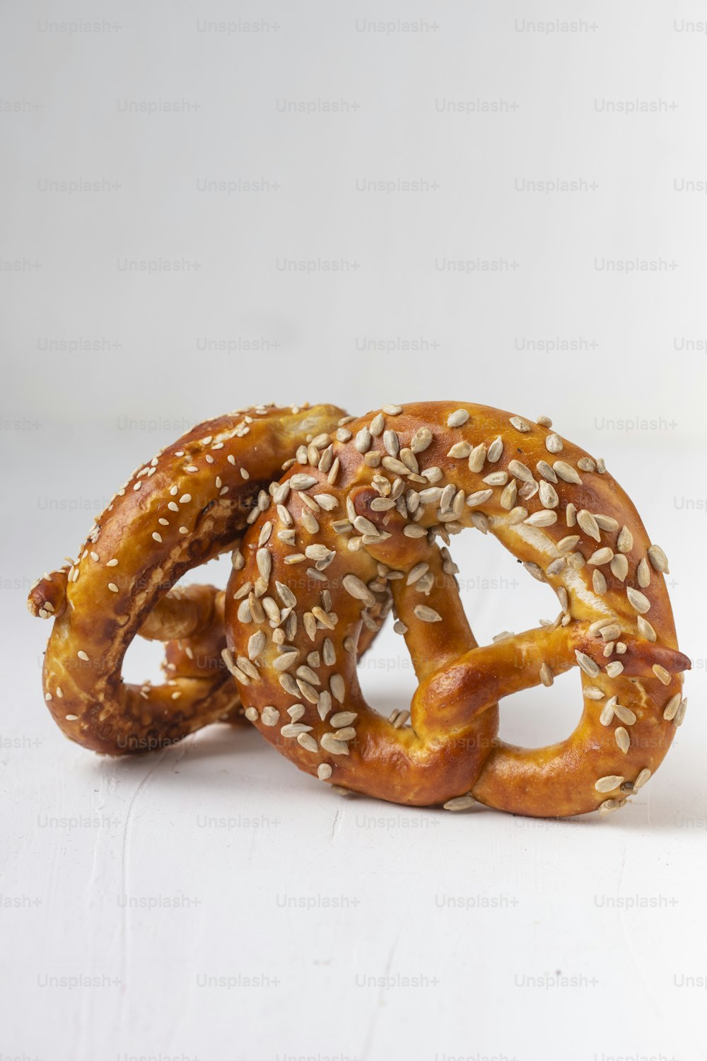 a couple of pretzels with sesame seeds on them