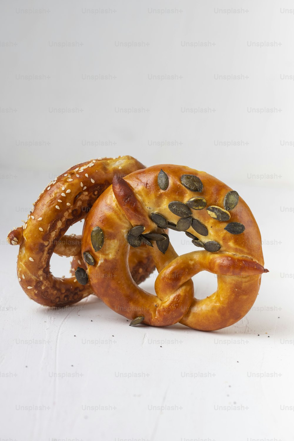 a couple of pretzels with seeds on them