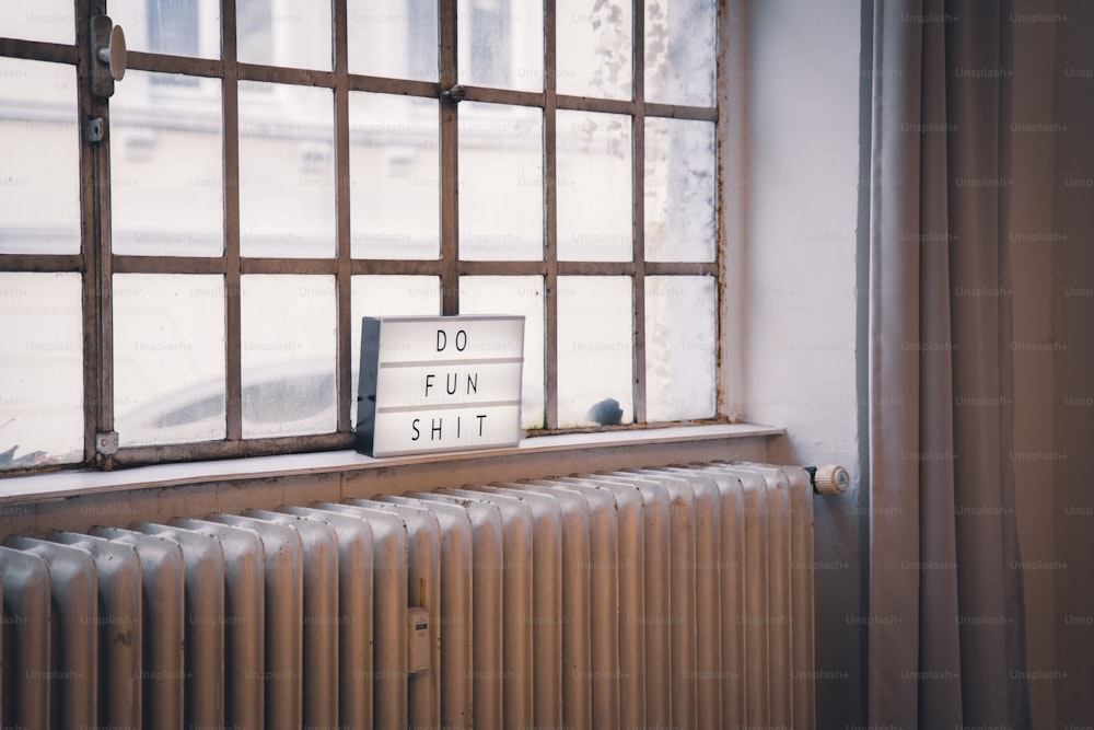 a window with a sign that says do fun shit