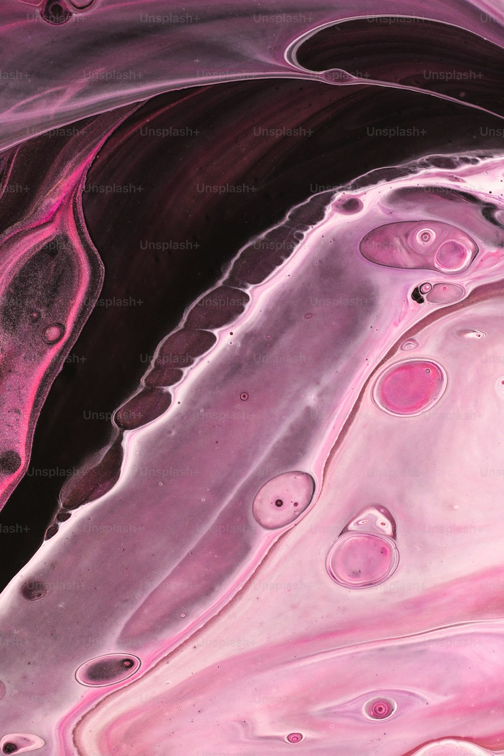 a close up of a pink and black substance