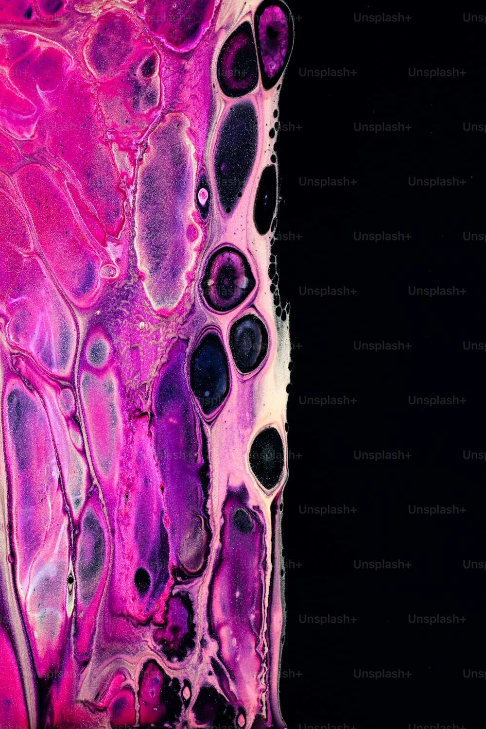 a close up of a purple and black liquid