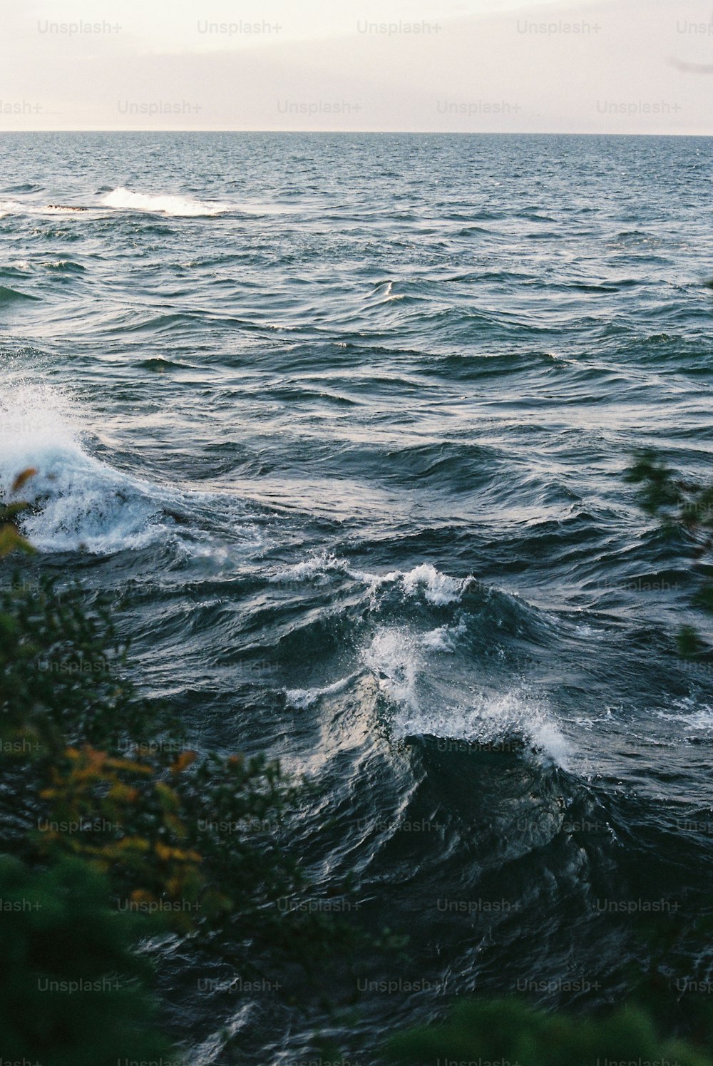 a large body of water with waves coming in to shore