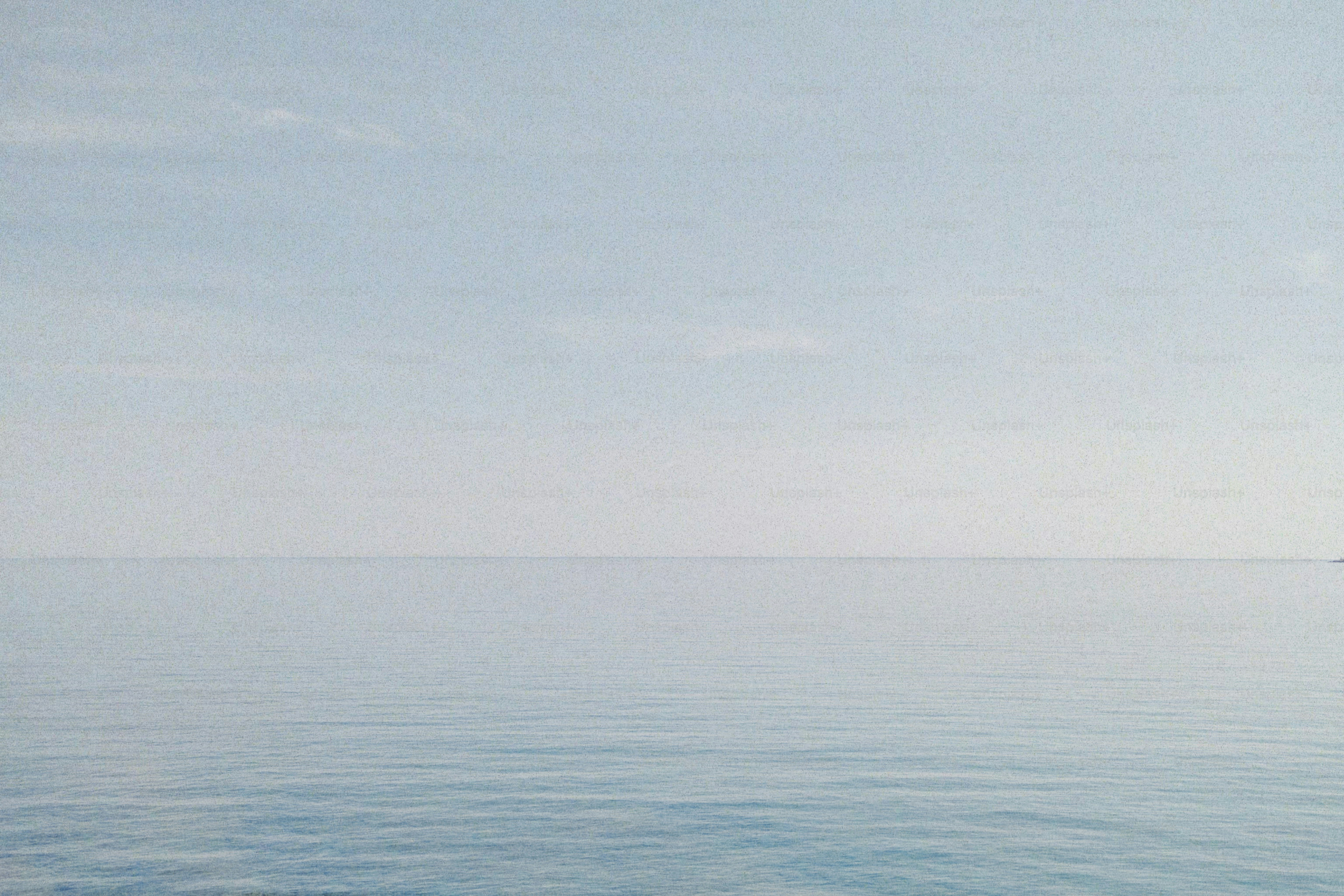 a large body of water with a boat in the distance