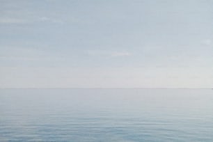 a large body of water with a boat in the distance