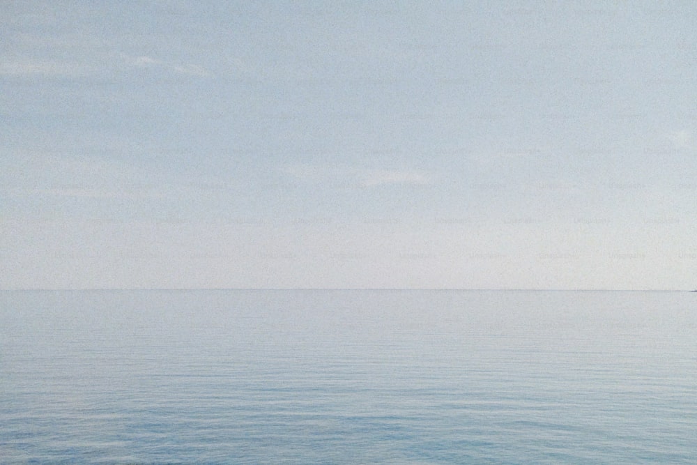 a large body of water with a boat in the distance