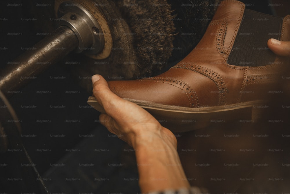 a pair of brown shoes being worked on