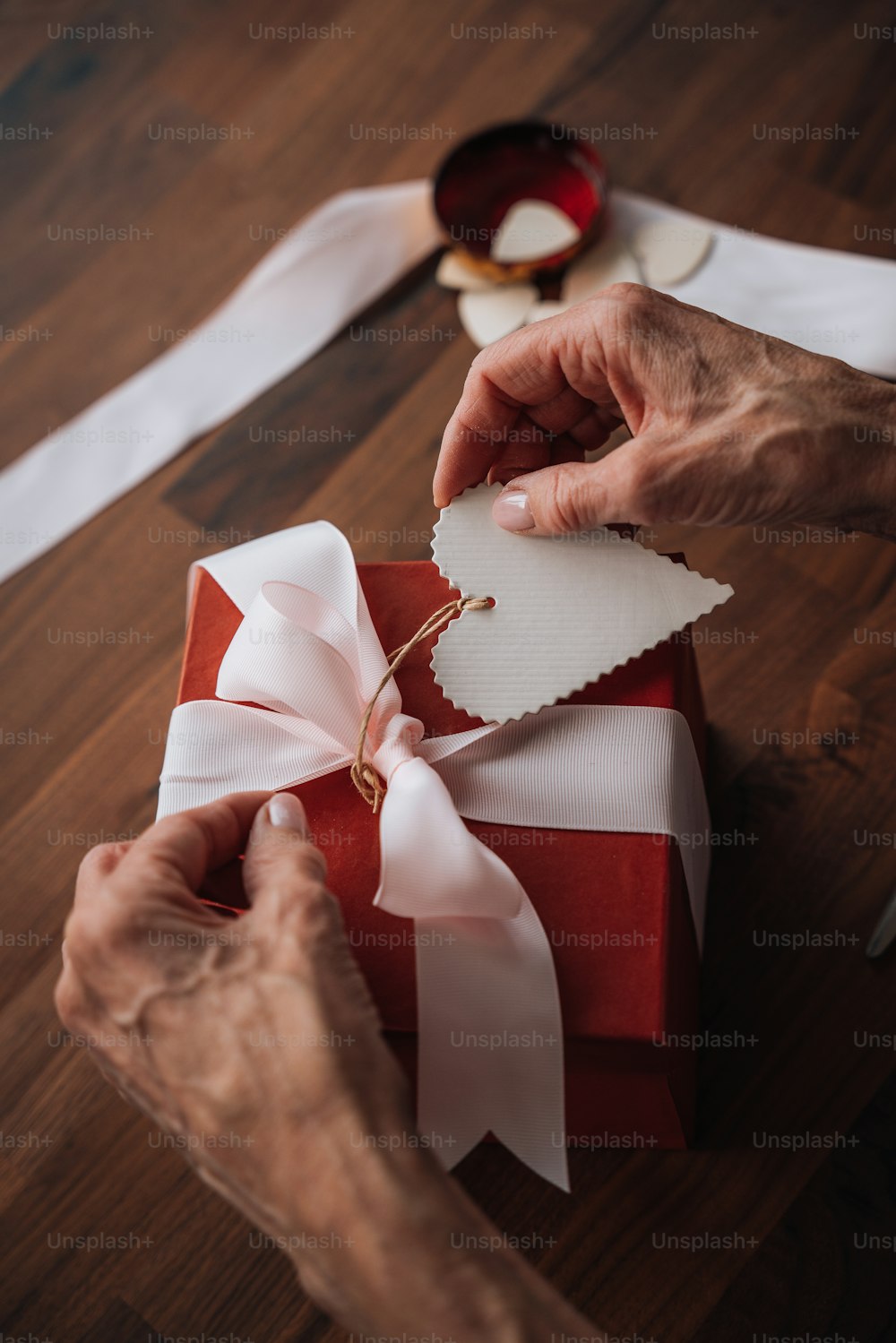 a person wrapping a present with a ribbon