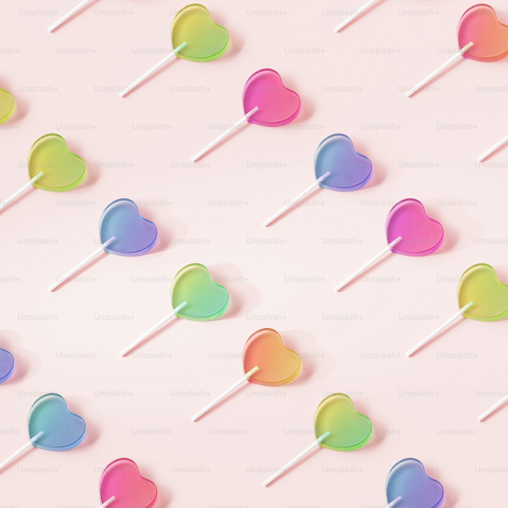 a group of lollipops sitting on top of a pink surface