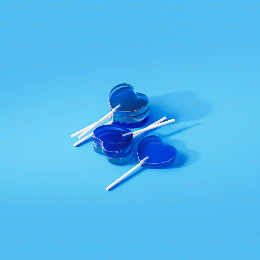 three blue bowls and two white chopsticks on a blue background